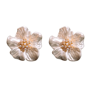Elegant gold-plated flower stud earrings with white petals and pearls on white background