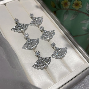 Macro view of fan-shaped sterling silver earrings with pavé set zircon crystals