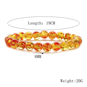 Detail of 8mm amber beads with flower inclusions showing length and weight measurements