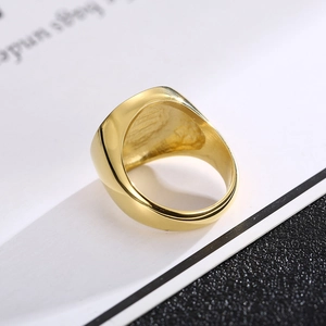 Macro shot of polished gold signet ring showcasing smooth finish and oval surface
