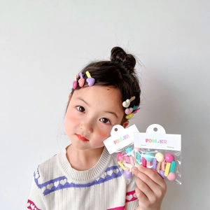 Colorful candy-colored bean and heart hair clips for kids in retail packaging