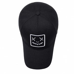 Classic black cotton baseball cap featuring a white embroidered smiley face patch
