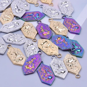 Macro view of rabbit and moon charms in gold, silver, and iridescent steel finishes