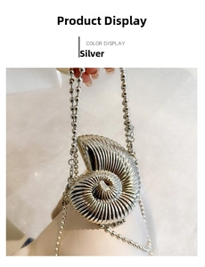 Close-up of silver shell-shaped evening clutch with metallic spiral texture and bead chain
