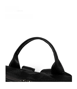 Detail of comfortable rounded top handle on black lychee texture leather backpack