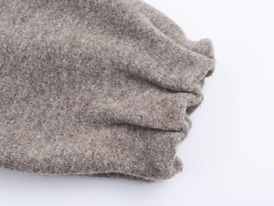 Detailed macro view of the knitted cuffs and thick plush fabric on a bomber jacket set