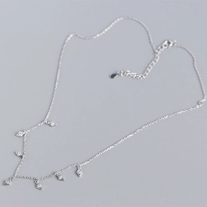 Close-up of S925 sterling silver tassel necklace with sparkling rhombus zircon pendants