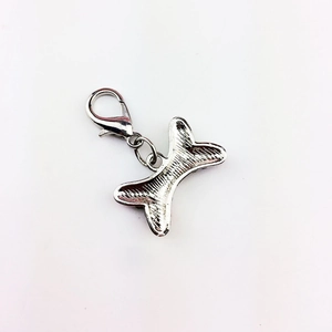 Detailed view of bone shaped silver metal pet tag with striped texture and lobster clasp