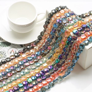 Close-up of rainbow luster rhombic glass beads in multiple vibrant colors for jewelry DIY