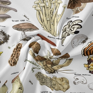 Close-up of vintage mushroom illustrations on white bohemian tapestry fabric