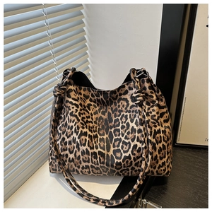 Close-up of leopard print tote bag with stylish knotted shoulder strap in sunlight