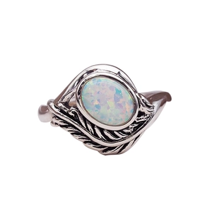 Vintage opal ring with oval gemstone and detailed leaf engravings on silver band
