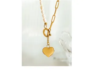 Detail of freshwater pearl necklace with gold OT clasp and polished heart pendant