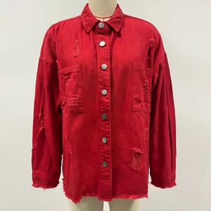 Detail showing distressed ripped texture and chest pockets on red denim jacket
