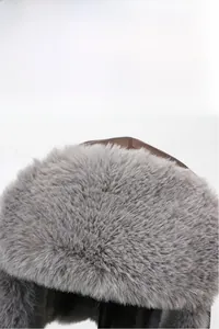 Detail of warm winter trapper hat with brown faux leather and thick grey plush lining