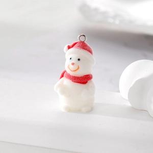 Close-up of a flocking snowman pendant with red hat and scarf for DIY jewelry making