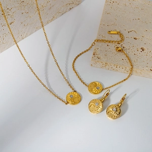 Detail of 18K gold plated celestial relief necklace set with sun moon star pendant