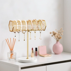 Golden hexagonal jewelry stand with white marble base for bracelets and watches