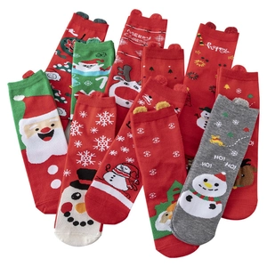 Red and green Christmas socks with cartoon reindeer, Santa Claus, and snowflake patterns