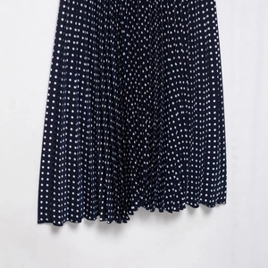Navy blue polka dot pleated midi dress with halter neck and matching waist belt
