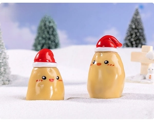 Macro view of Christmas potato resin figurines in a winter snow scene landscape