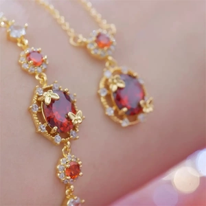 Elegant 18K gold plated set featuring red oval gemstone necklace and butterfly earrings