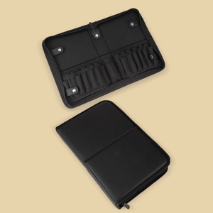Close-up of a professional black makeup brush travel case with multiple slots and zipper