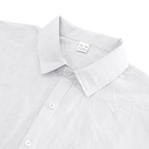 Macro detail of the XL linen shirt collar showing fabric texture and care label