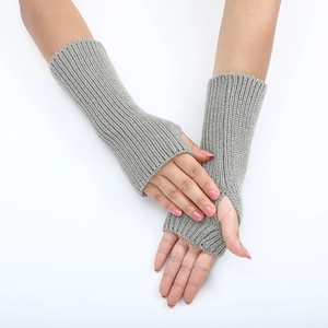 Detail of grey striped knitted fingerless gloves showing ribbed texture and wrist coverage