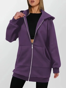 Detail view of oversized deep purple zip-up hoodie featuring a loose fit and side pockets