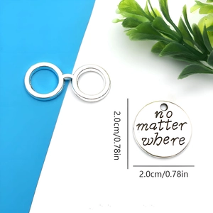 Detailed view of silver alloy graduation pendant and clasp with 2cm diameter measurement