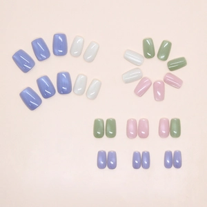 Flat lay of colorful jelly press-on nails in purple, beige, green, and pink shades