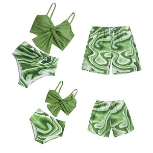 Detailed set of family matching swimwear featuring green marble print on white background