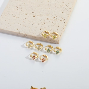 French vintage style gold hoop earrings with colorful enamel evil eye charms on stone
