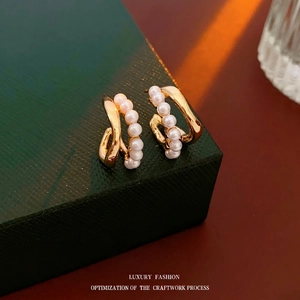 Elegant gold double-layered C-shaped hoop earrings with pearls in minimalist French style