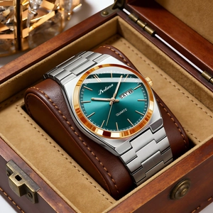 Detail of luxury men's watch with green dial and gold bezel in premium wooden gift box