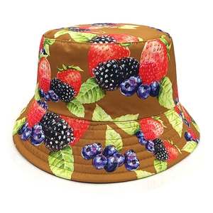 Close-up of strawberry and berry print detail on brown fabric sun bucket hat