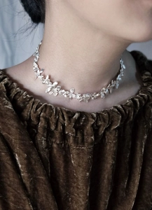 Close-up of handmade silver flower choker necklace featuring intricate floral clusters