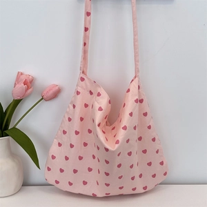 Detailed close-up of pink heart pattern on high-quality canvas tote bag with tulips