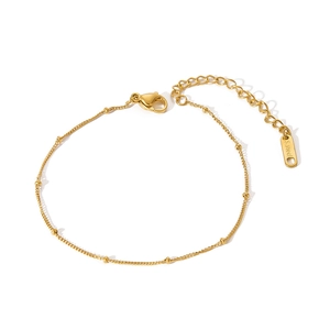 Macro detail of gold-plated stainless steel bead chain with lobster clasp and extender