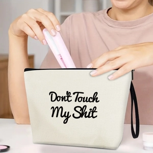 Portable cream canvas makeup bag with Don't Touch My Shit print and black zipper strap