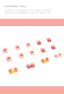 Detail of short press-on nails featuring grapefruit patterns, red glitter, and yellow drip art