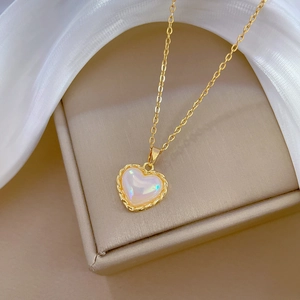 Elegant gold titanium heart necklace with iridescent resin and braided metal border