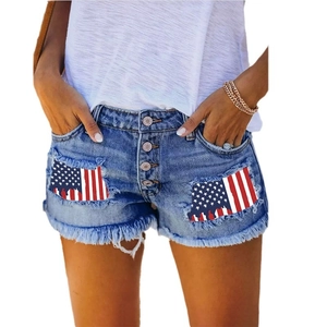 Women's denim shorts with American flag patch and distressed fringe hem detail