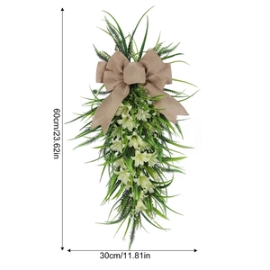 Detail of Easter lily teardrop swag with burlap bow and green leaves, 60cm height