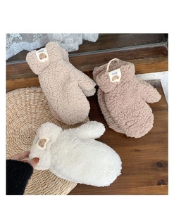 Three pairs of plush bear fleece mittens in beige, brown, and ivory with soft textures