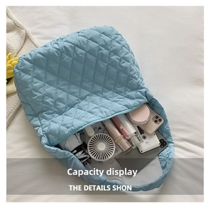 Detailed interior of the quilted light blue bag showing its large storage capacity