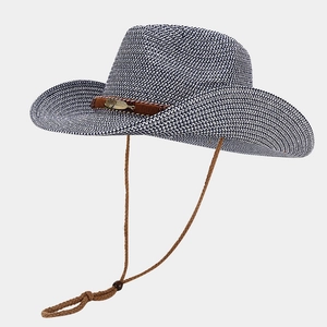 Detail view of woven cowboy hat with brown leather band and golden feather buckle