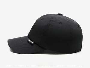 Side view of black quick-dry baseball cap with black leather logo label and six-panel design