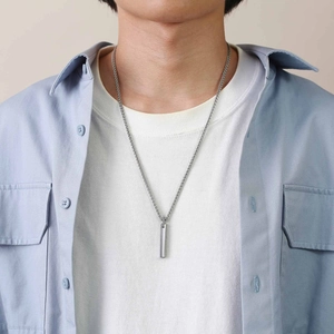 Macro view of polished silver tungsten bar pendant with twisted rope chain for men